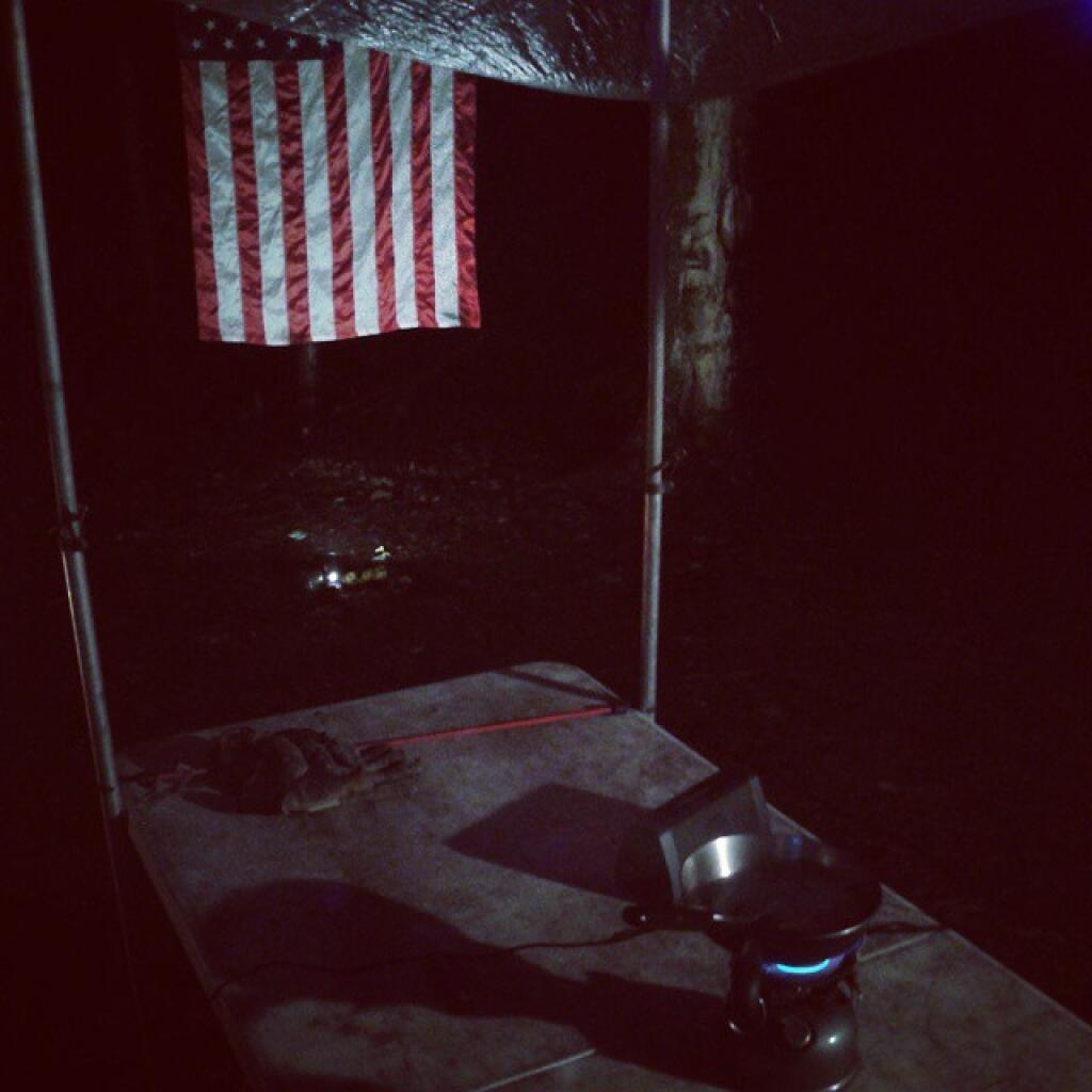 Photo: Cooking burgers under the tarp